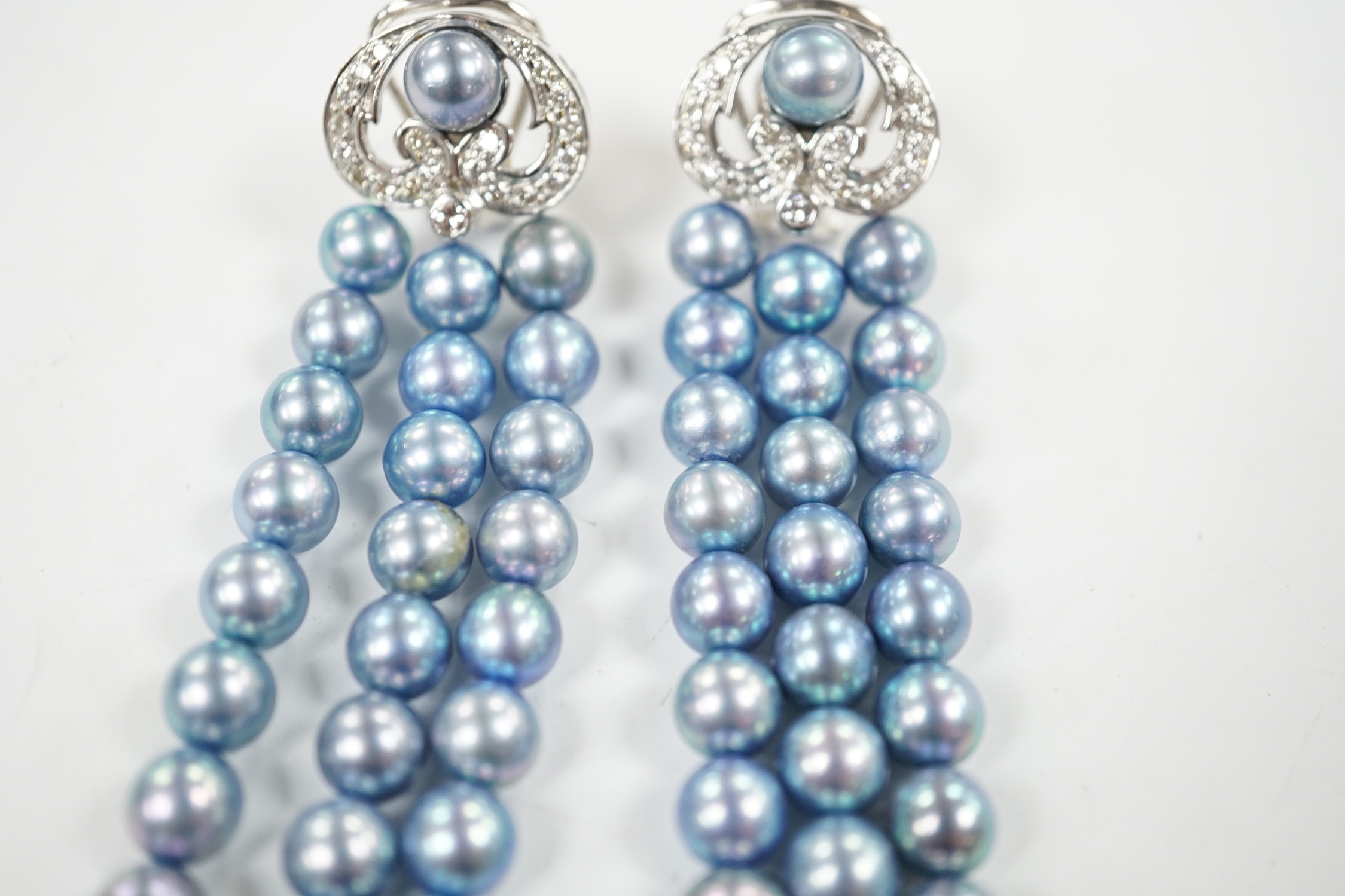A modern pair of white metal, diamond chip cluster and bluey/grey three row cultured pearl tassel drop earrings, 89mm.